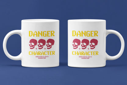 Danger Character – Keramiktasse (325 ml) – 325 ml Keramiktasse als Doppel-Mockup, hochwertiges Gaming- & Nerd-Design Produktfoto.